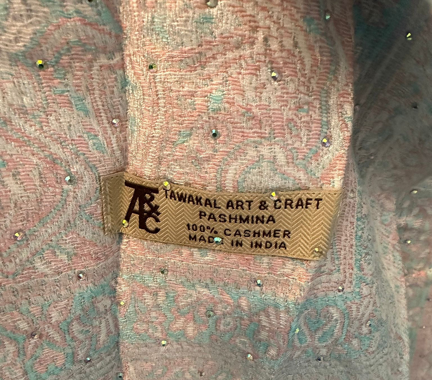 Pashmina with a brand label on a textured background